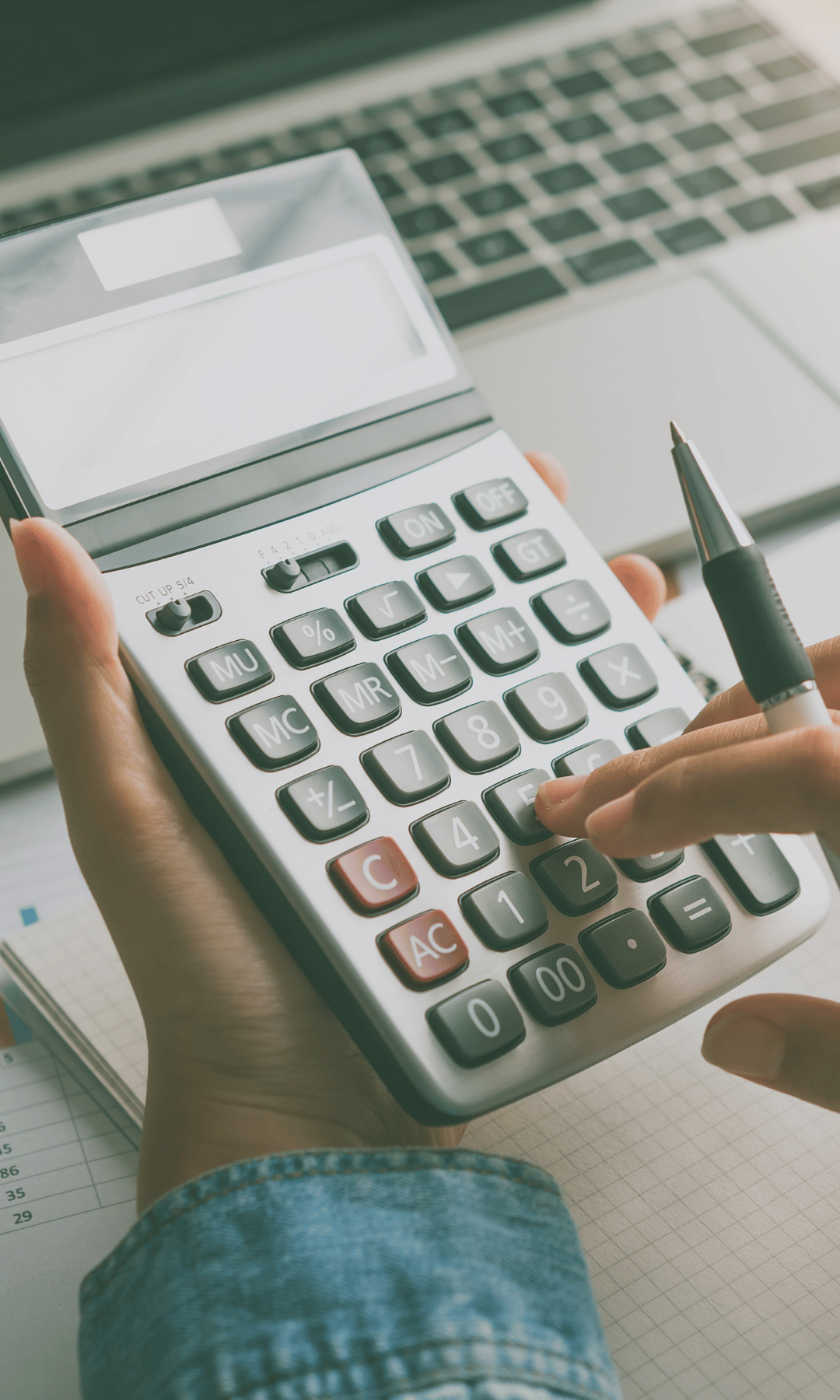 A Person Using A Calculator