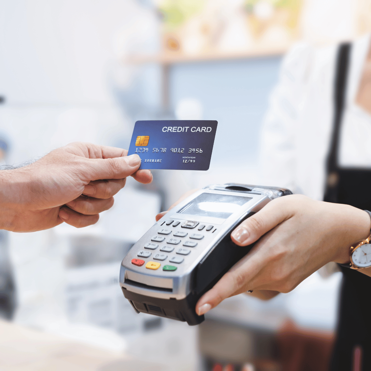 Customer Using Credit Card for Payment to Owner of a Cafe