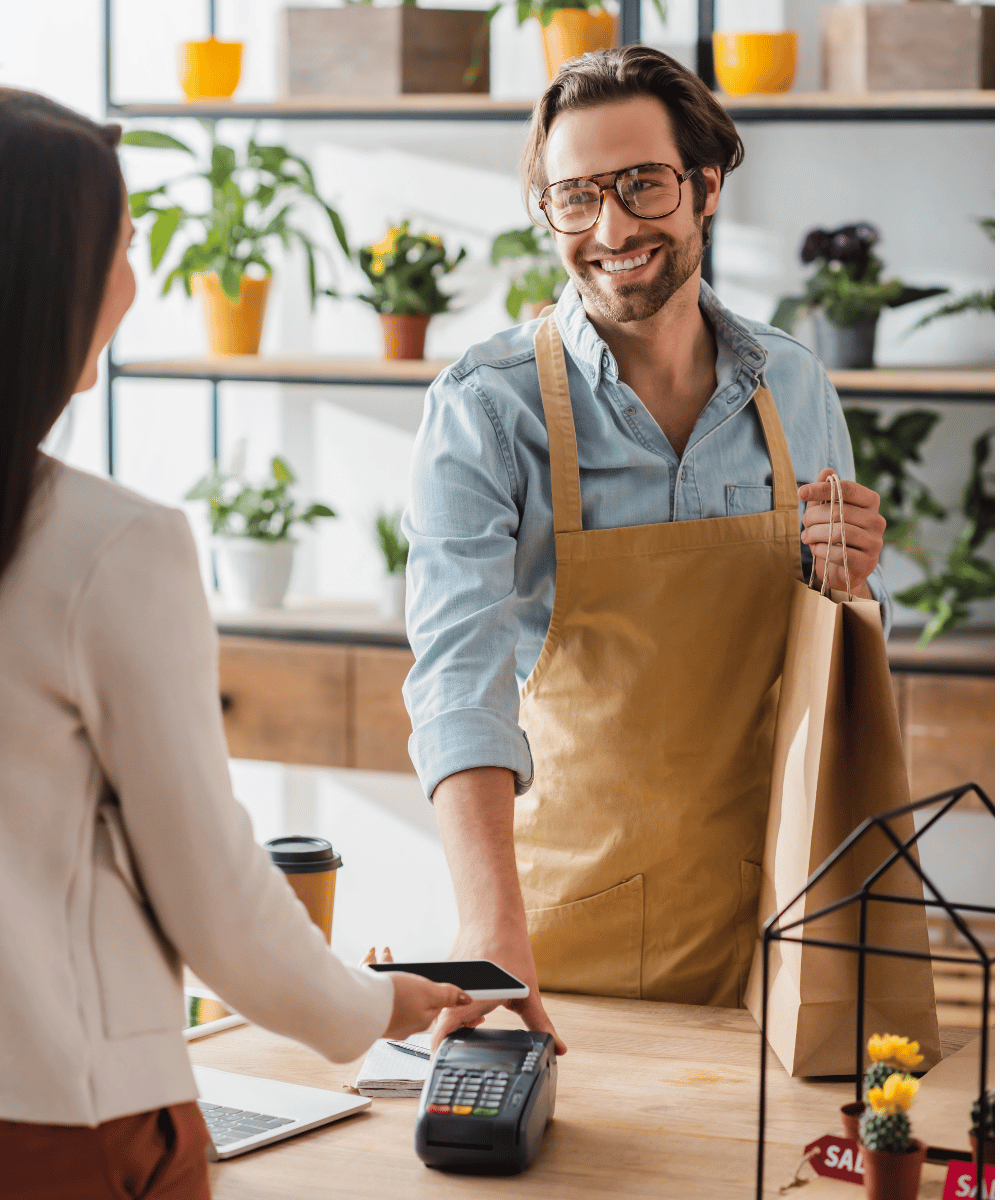 Plant Shop Owner Taking a Card Payment from a customer